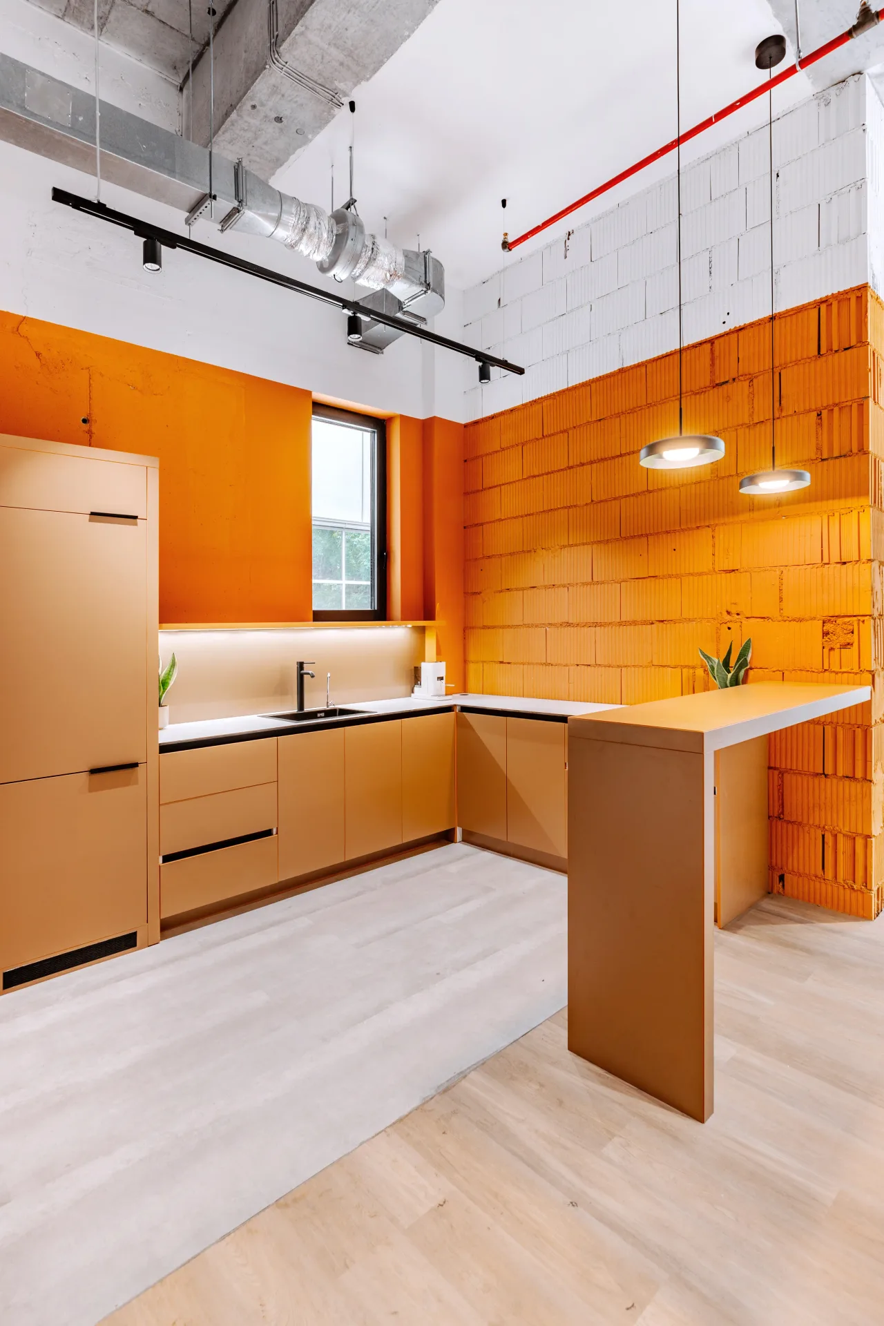 The orange brick kitchen with a timber counter and pendant lights