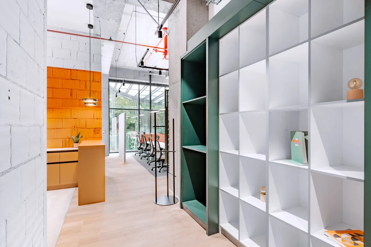 White shelving in a green frame beside the kitchen