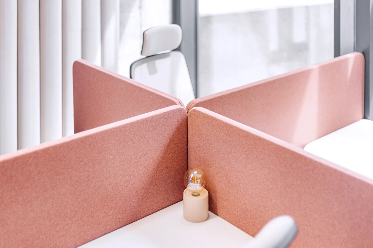 Pink desk screens meeting at a corner