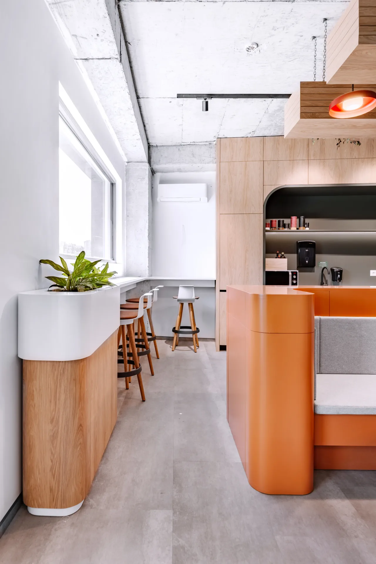 A white planter and a booth seat beside the kitchen