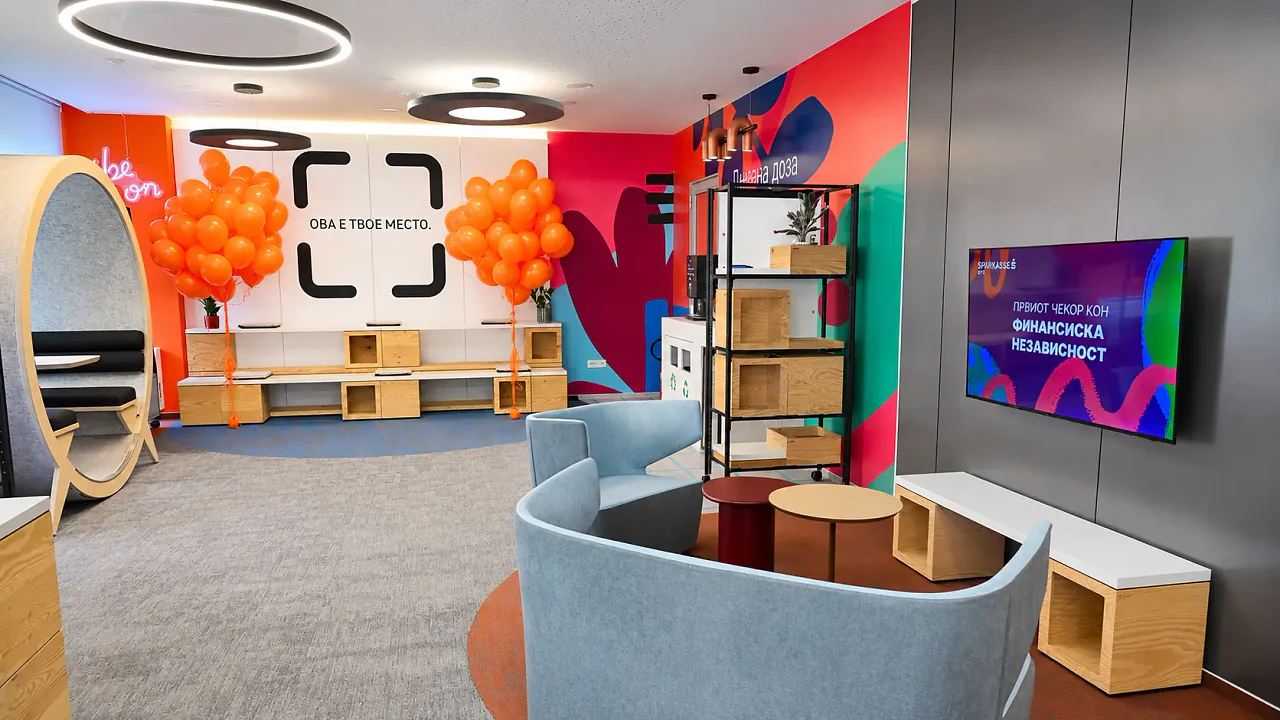 The Sparkasse office lounge, a colourful mural wall and soft seating