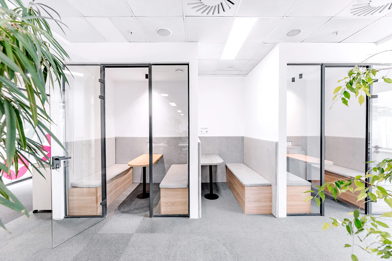 Small glass rooms with bench seating for calls