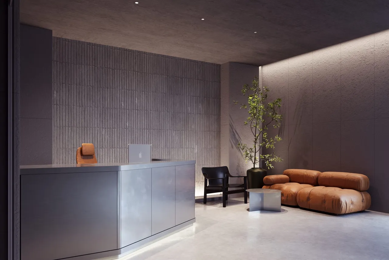 The Toros reception, a stone counter and soft seating in a dark lobby